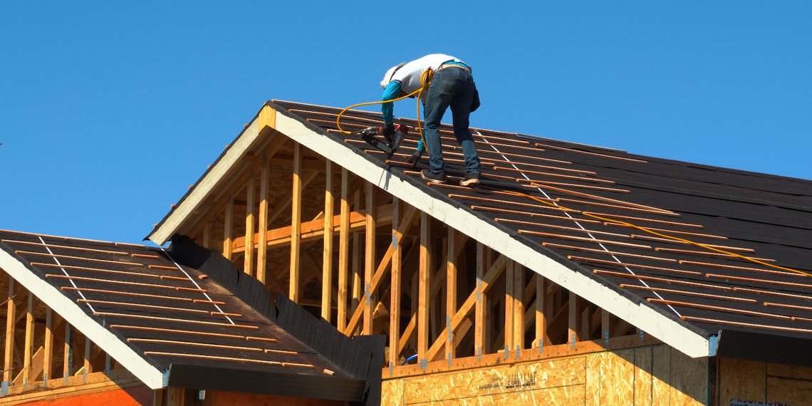 Roof repair work on a Metro Atlanta home with workers on a ladder