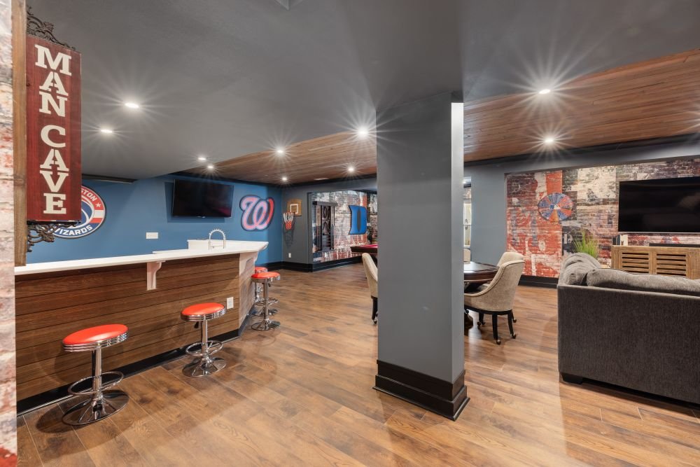 Chic basement lounge design with distinct furniture zones