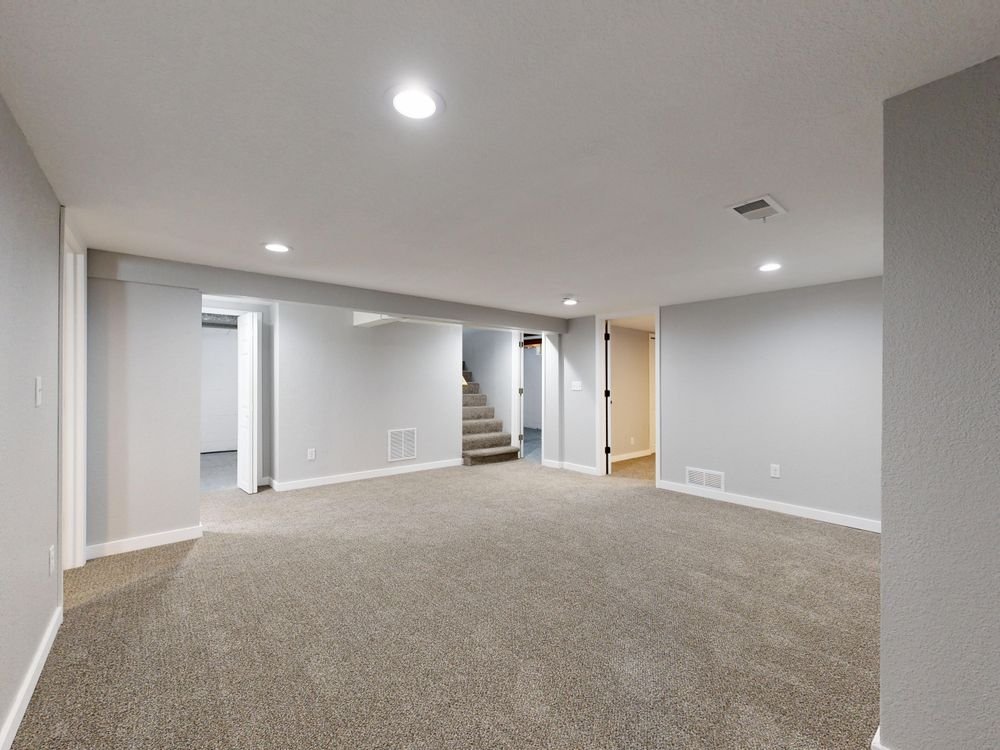 Spacious modern basement with neutral design after finishing