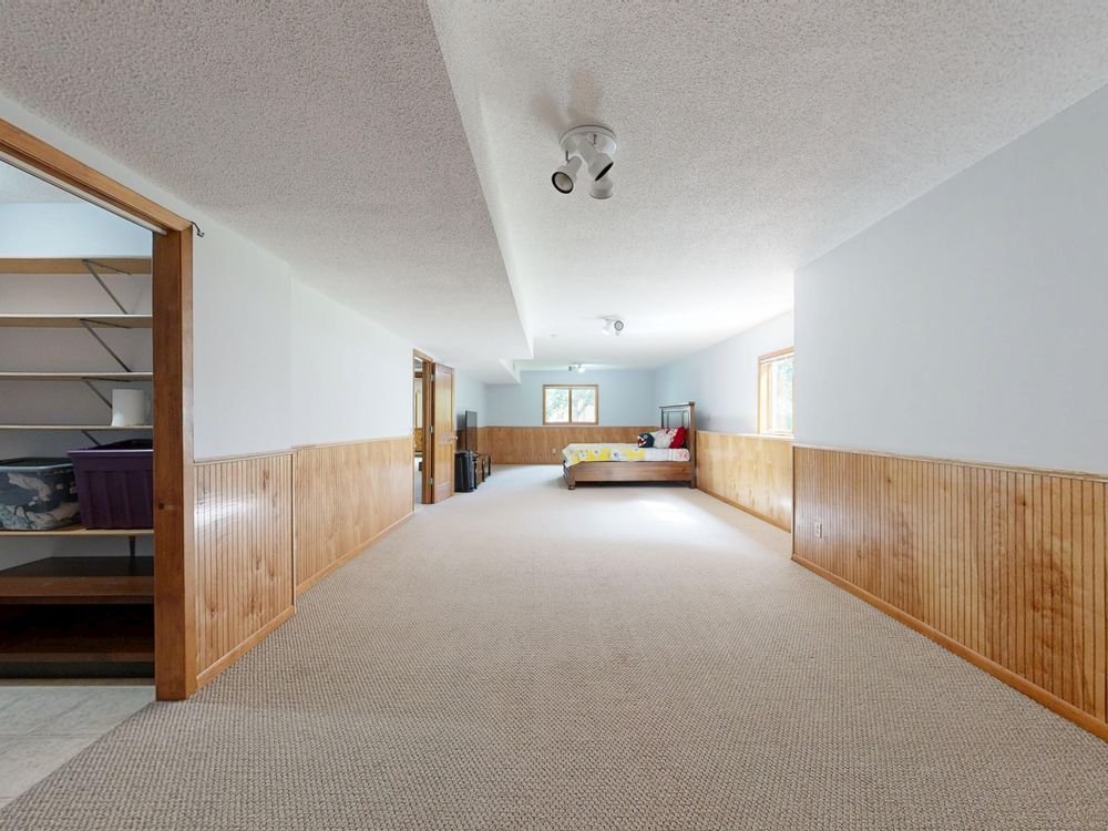 Spacious basement room with cozy recreation-space interior design