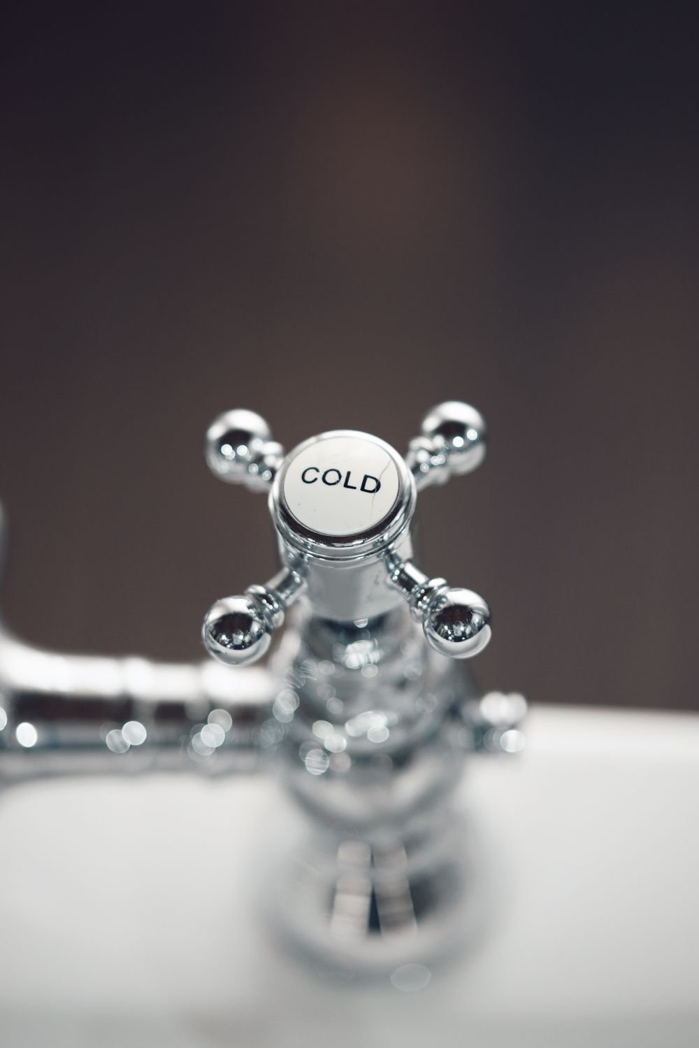 Close-up of a chrome bathroom faucet fixture