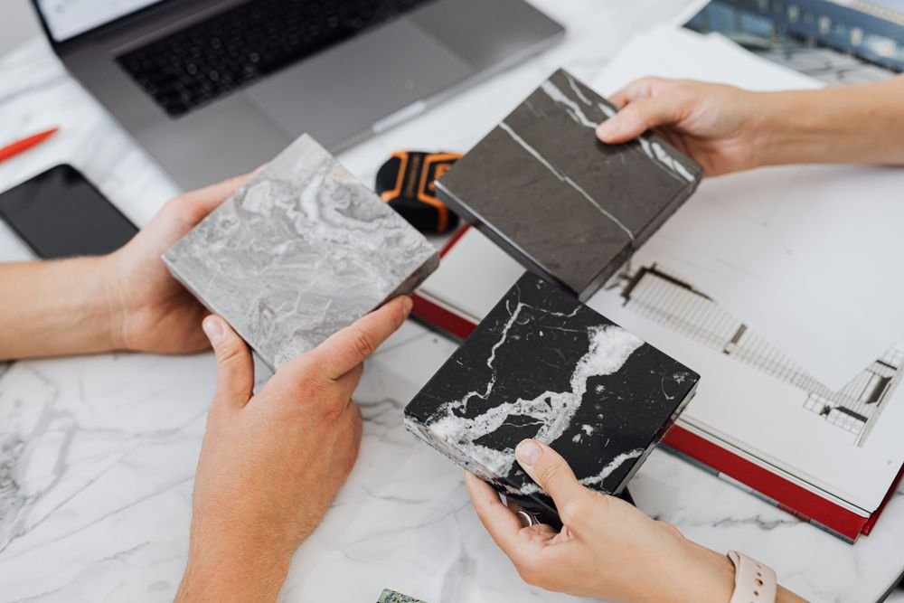 People comparing tile samples for a bathroom remodel