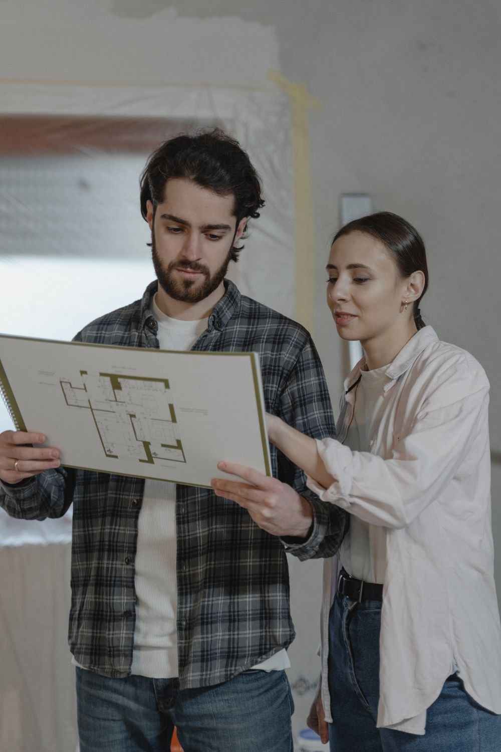 Couple reviewing a home renovation blueprint together