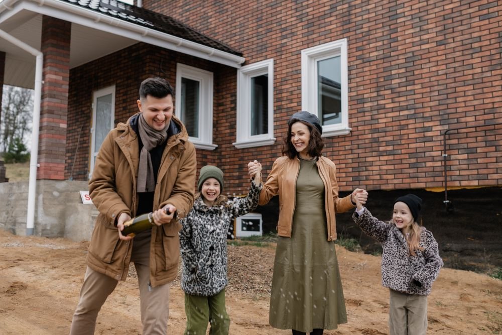 Family celebrating in front of their upgraded home