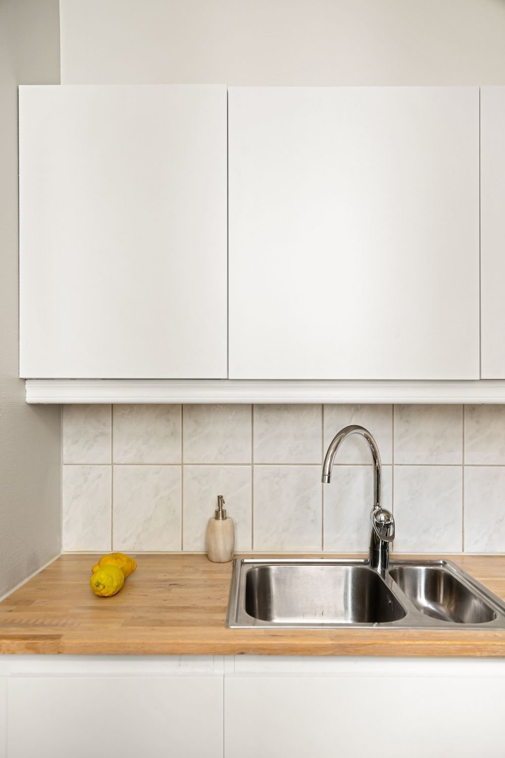 Bright finished kitchen with white cabinets after a remodel