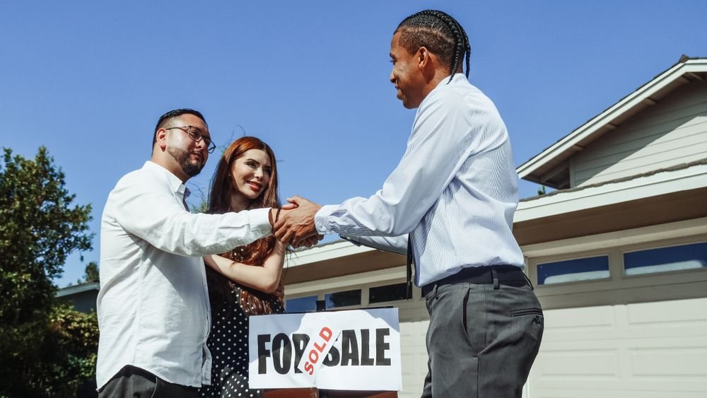 Professional buyer's agent showing Atlanta home to clients in upscale neighborhood