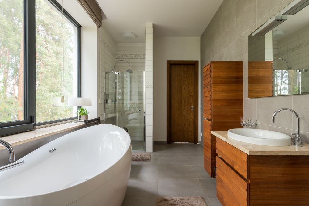 Modern renovated bathroom with large window and clean bathtub