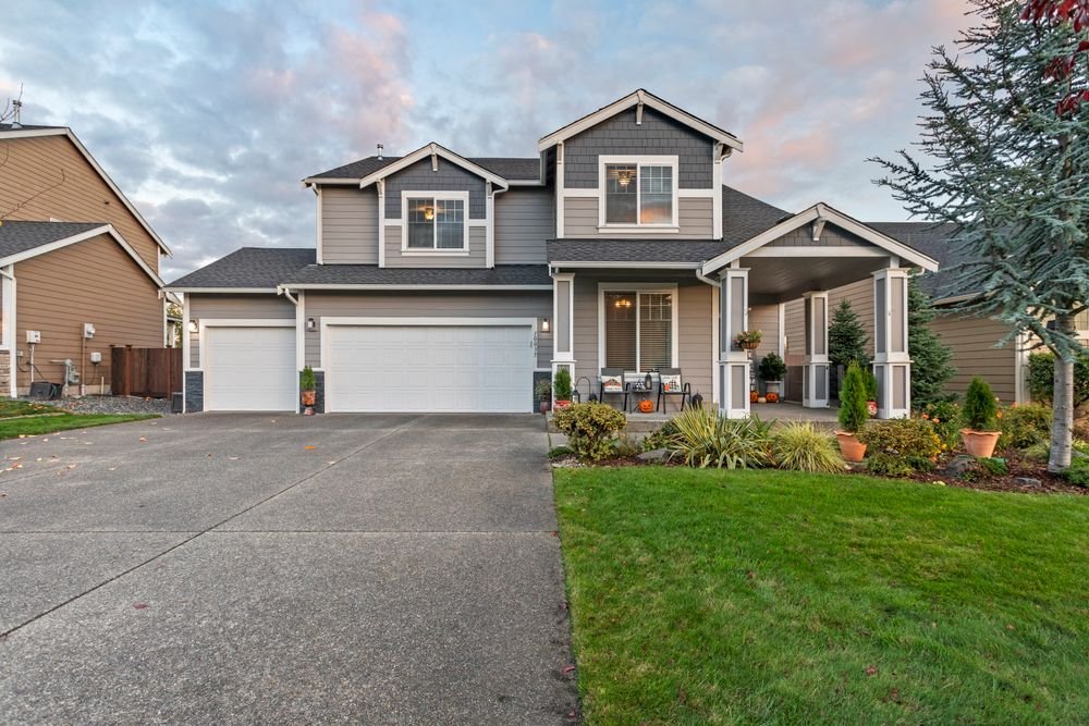 Well-maintained suburban home with lawn and garage exterior